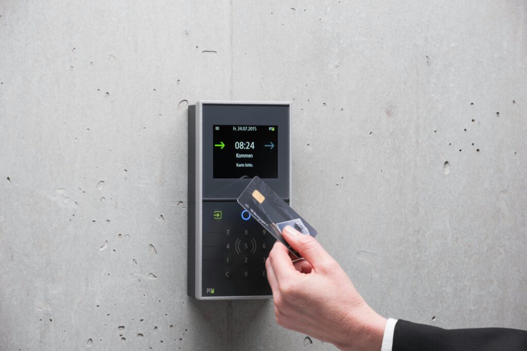 pexels photo 13657444 13657444 A businessman uses a secure card reader access system against a concrete wall.